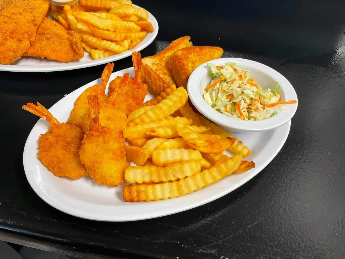 Golden fried chicken strips with fries and slaw